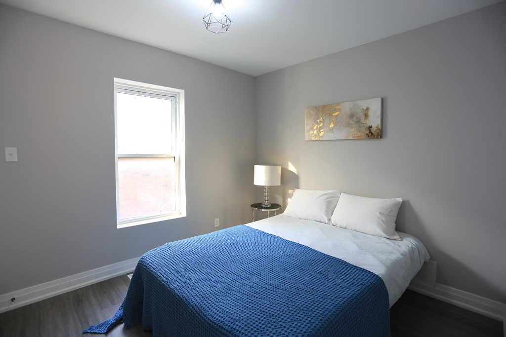 a bedroom with a bed and a window