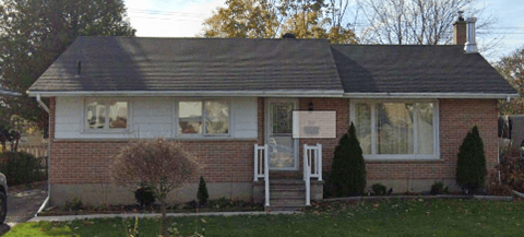 a brick house with a sign in the window