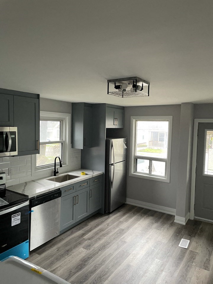 a kitchen with a sink and a refrigerator
