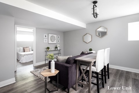 a living room and dining room with a table and chairs