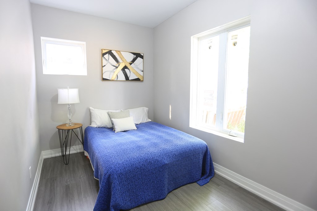 a small bedroom with a bed and a window