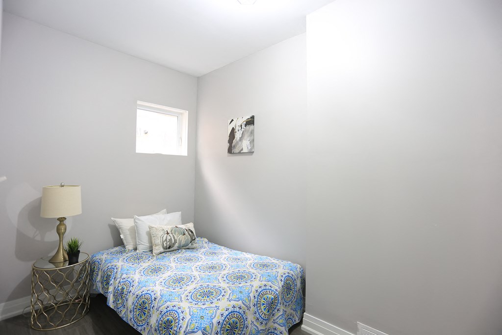 a small bedroom with a bed and a window