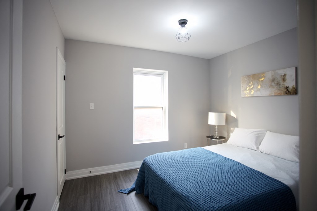 a bedroom with a bed and a window