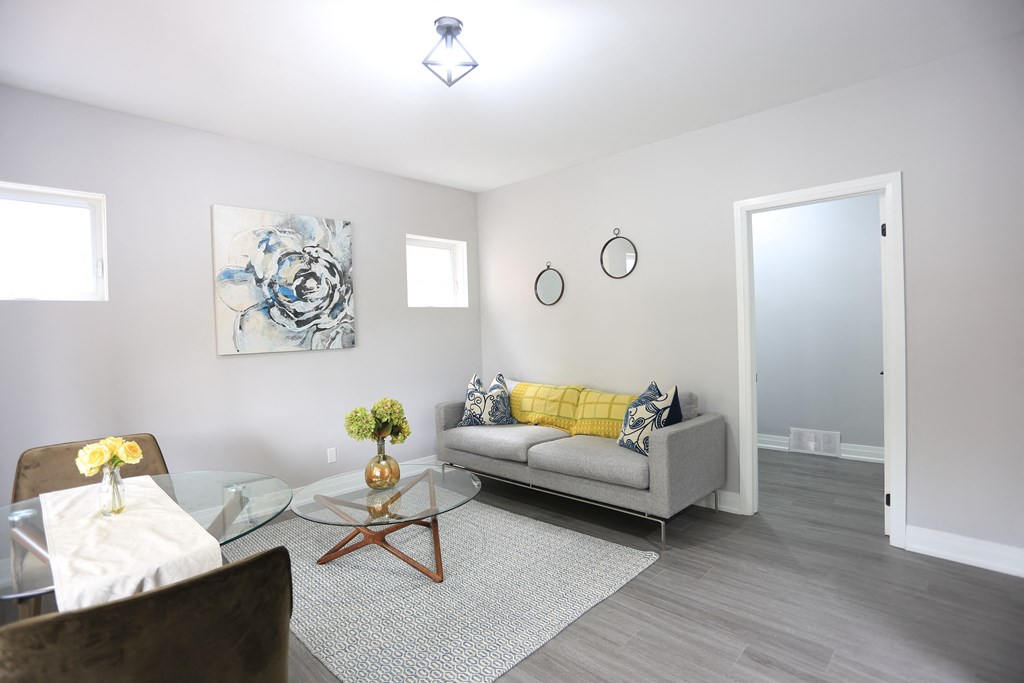a living room with a couch and a glass table