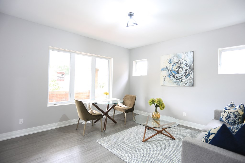a living room with a table and chairs and a couch