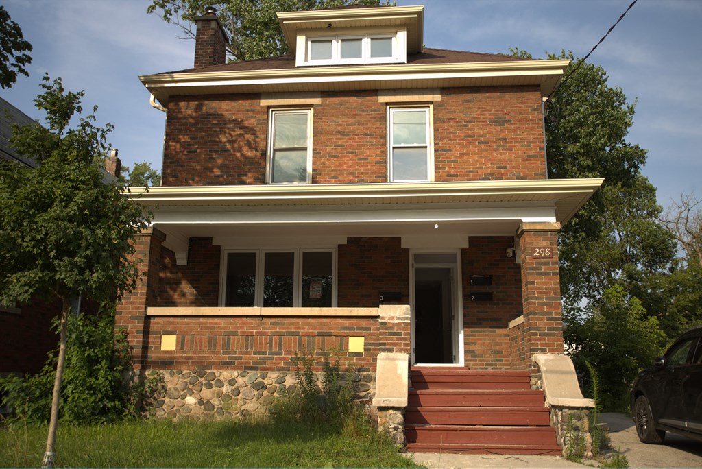 the front of a brick house with steps