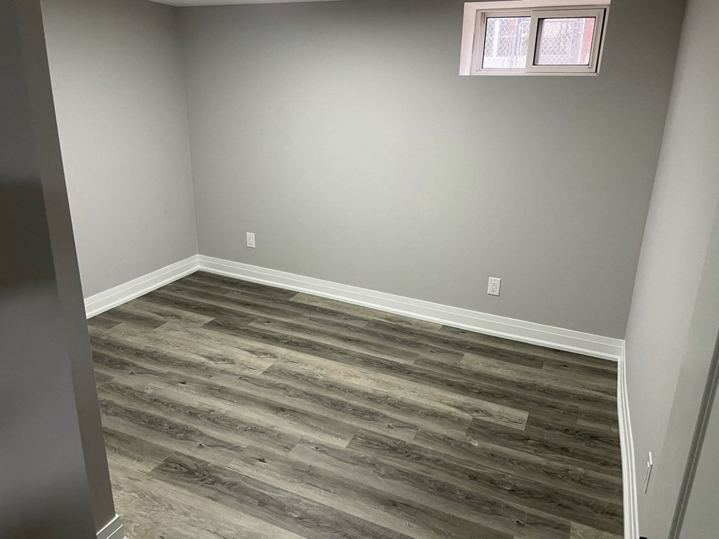 a room with wood flooring in it and a window