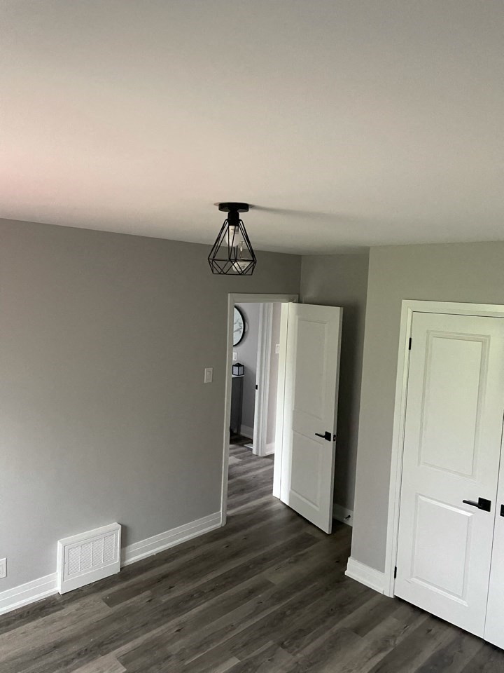 a living room with gray walls and a wood floor