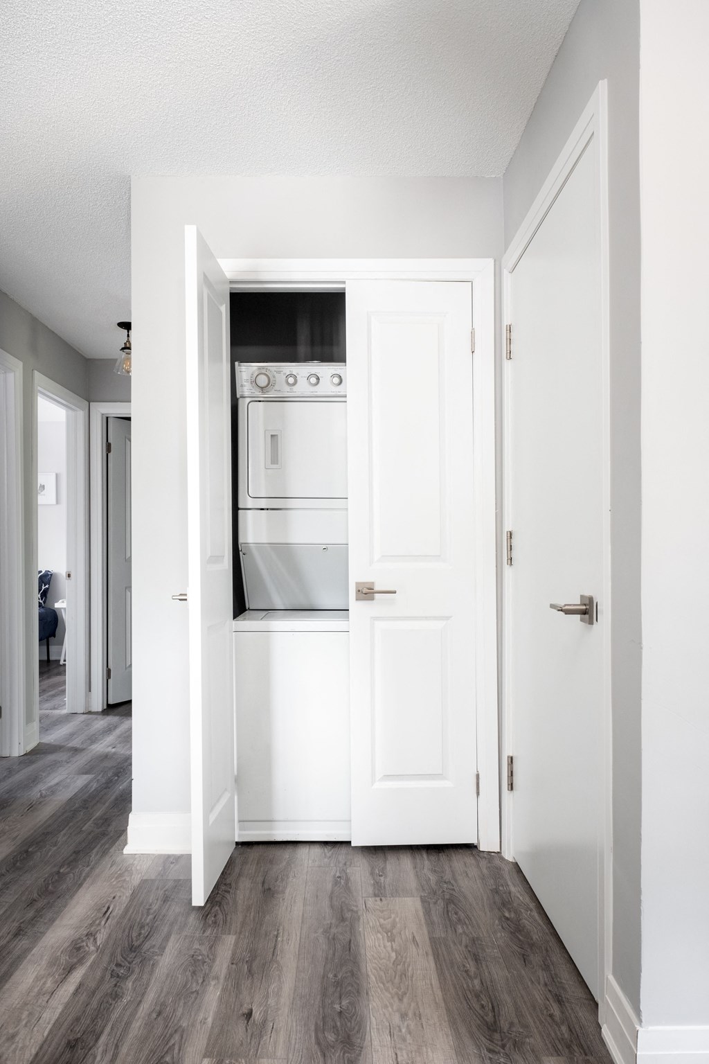 an empty kitchen with white cabinets and a stove and oven
