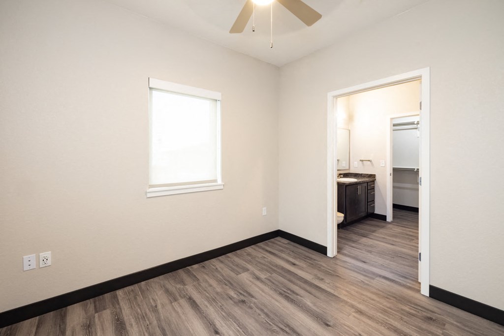 a living room with wood flooring and a ceiling fan