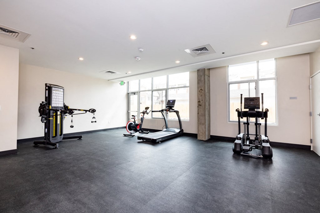 the gym has plenty of exercise equipment at the flats at west end apartments