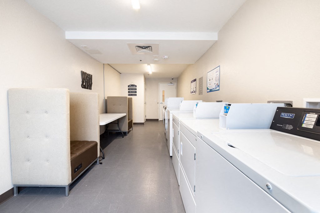a room with a counter and a printer and desks