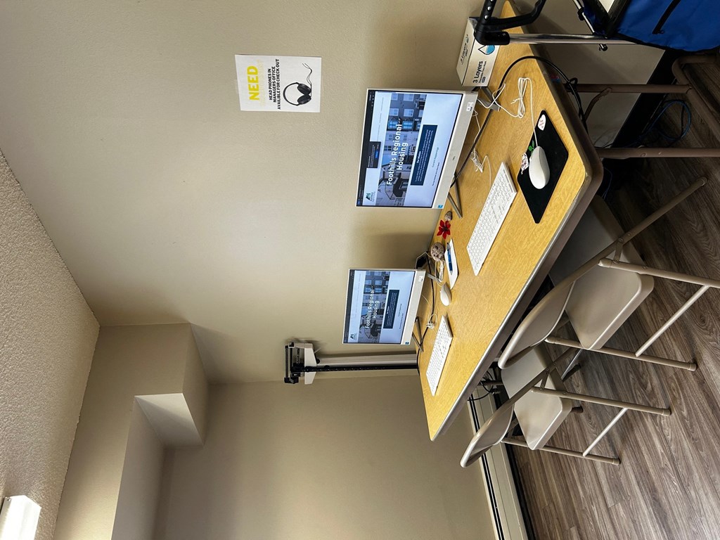 an overhead view of a room with a desk and a computer