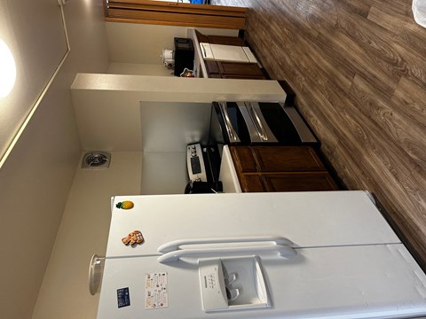 an overhead view of a kitchen with a refrigerator and a sink