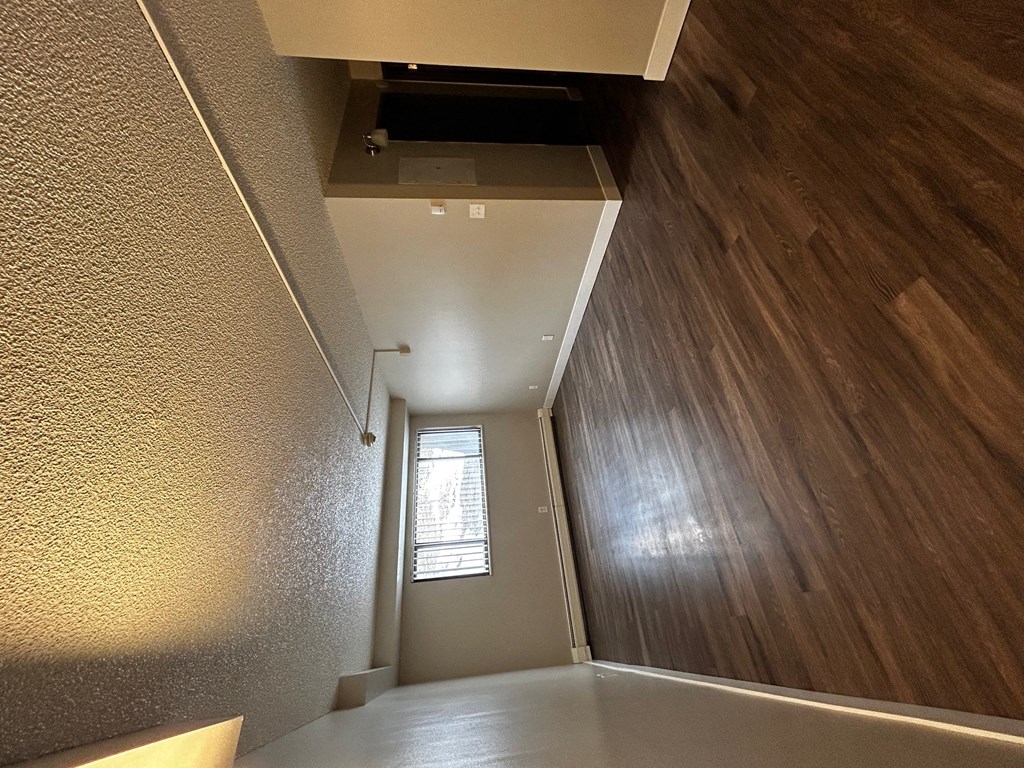 a view of the hallway from the bottom of the stairs looking up to the ceiling