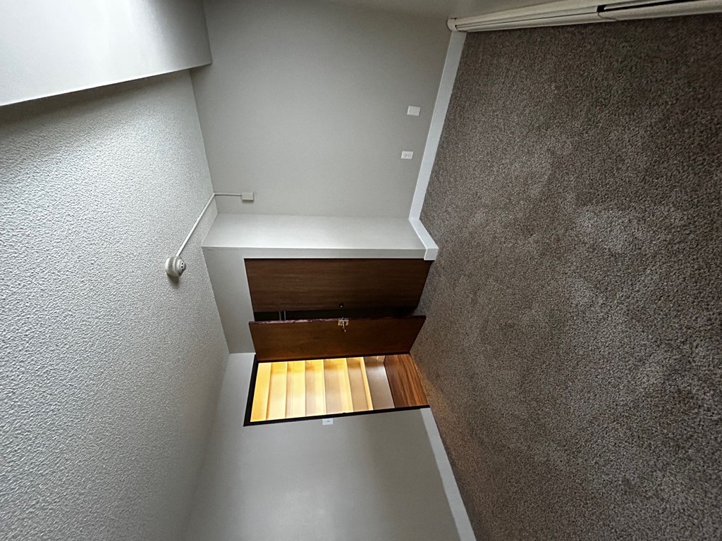 a look down the stairs from the top of a closet