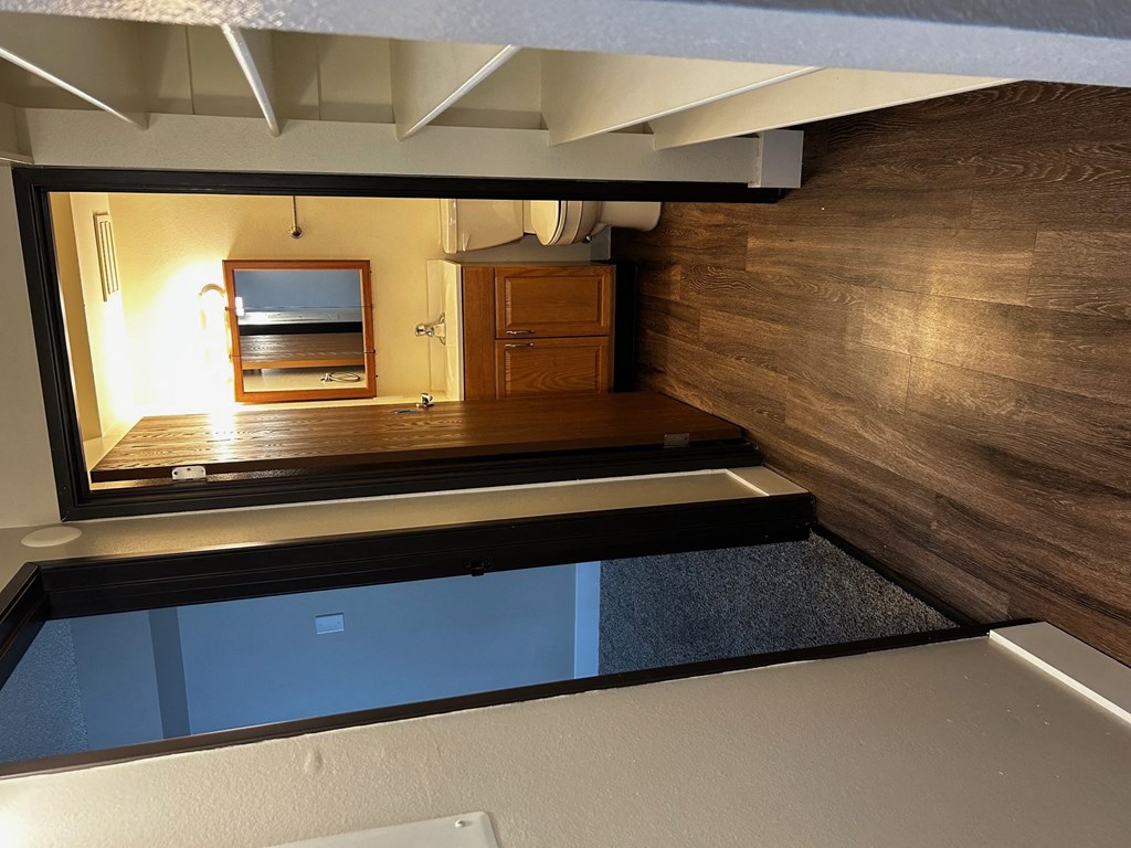 a view of the living room from the bottom of the stairs