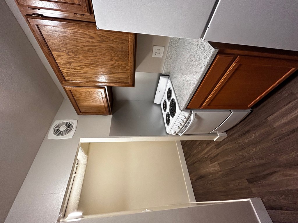 an overhead view of a kitchen with a stove and a microwave