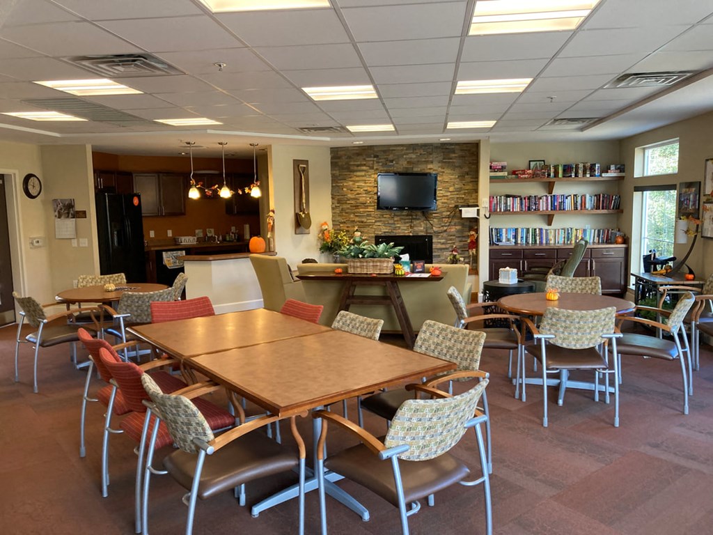 a dining room and living room with a table and chairs