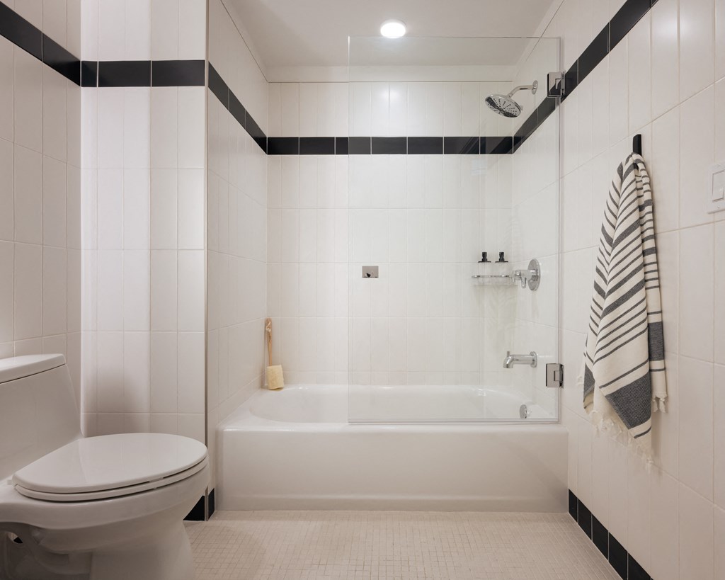 bathroom with large shower tub and under sink storage