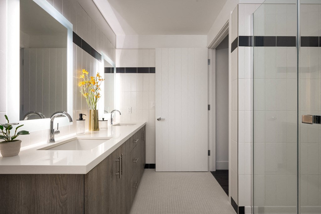 bathroom with large shower tub and under sink storage