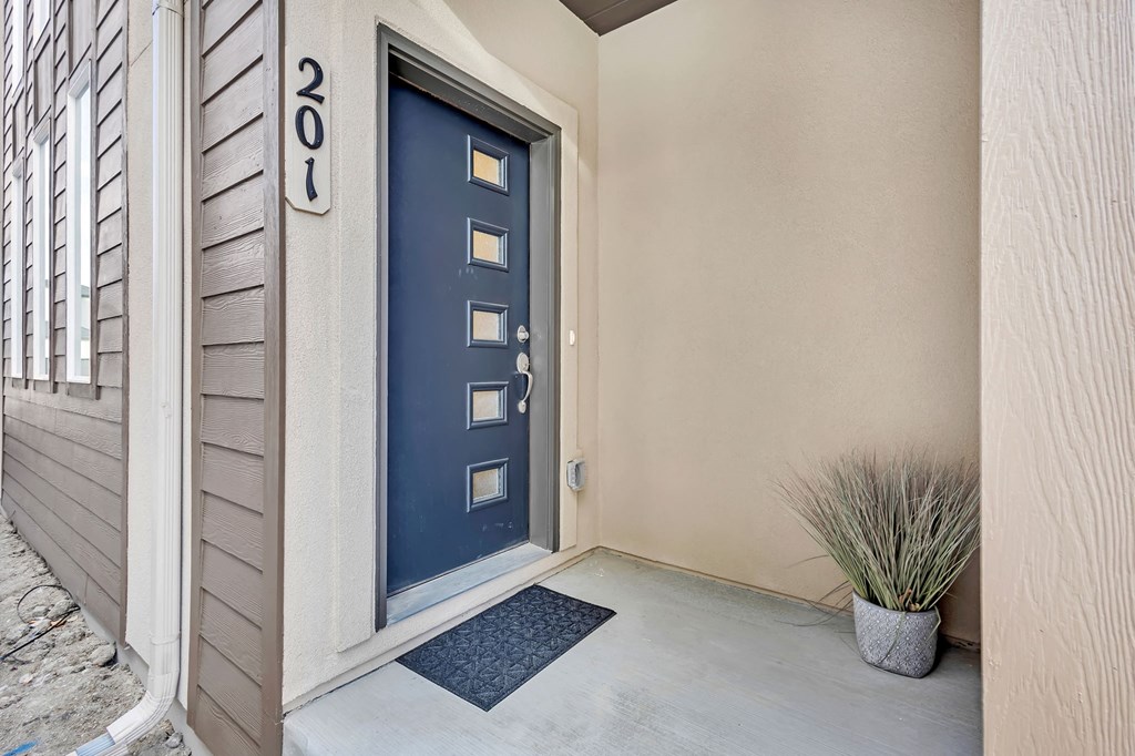A blue door with a number 201 on the wall above it.