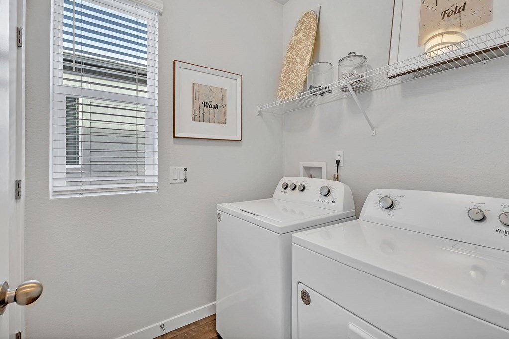 A white washer and dryer in a laundry room.