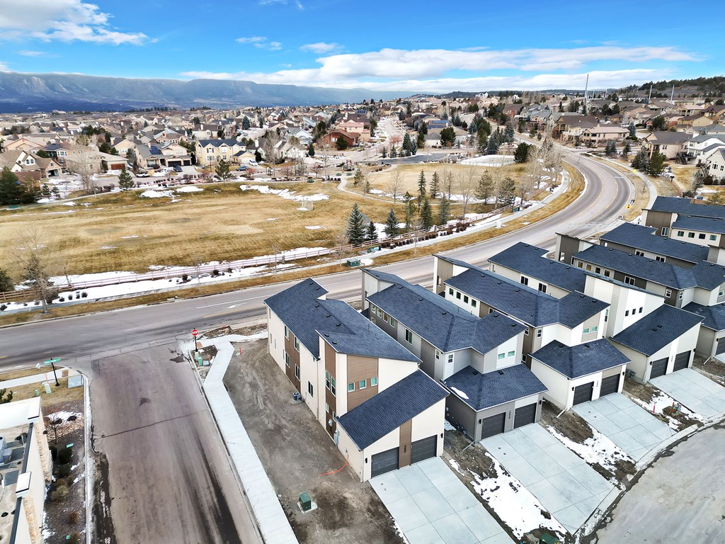 A road with a curve in the middle of a residential area.