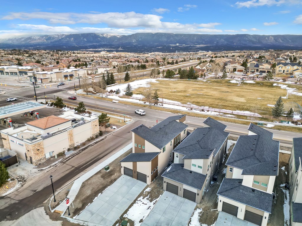 A view of a town with houses and buildings from a high vantage point.