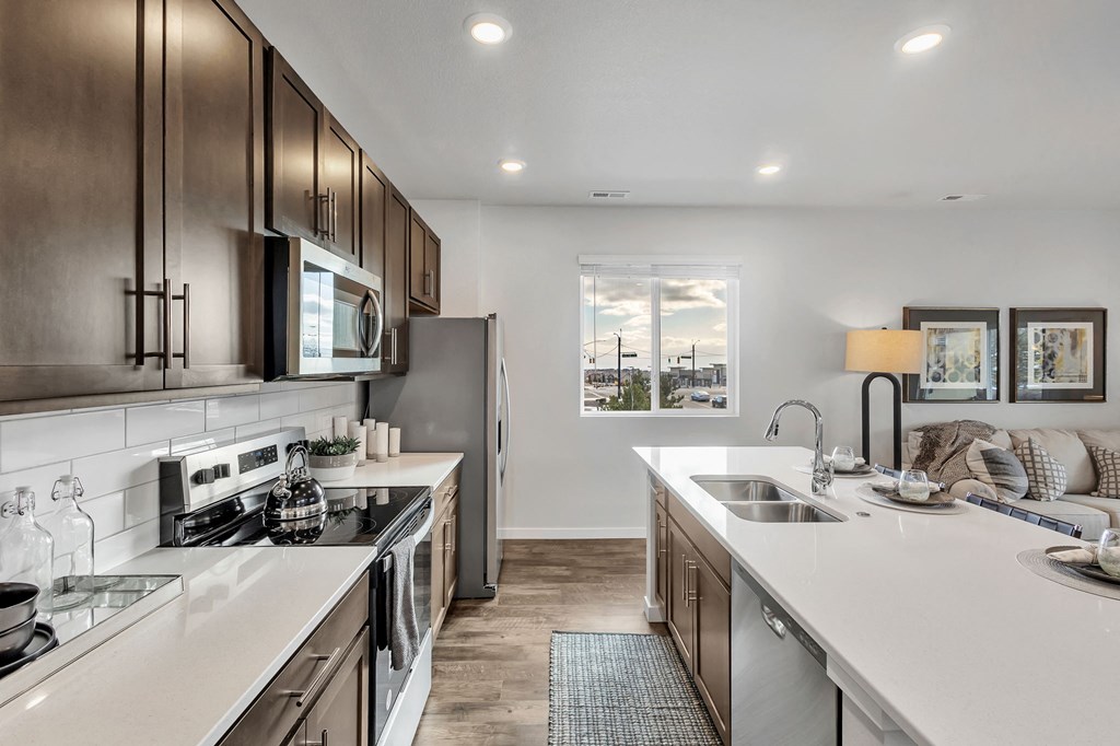 A modern kitchen with stainless steel appliances and wooden cabinets.