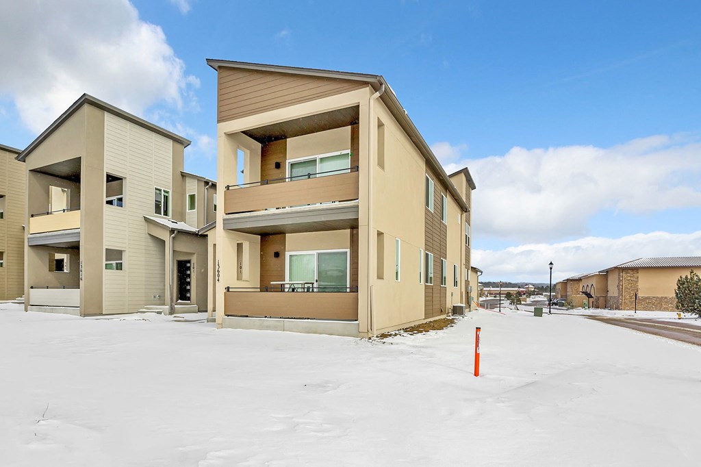 A row of houses with snow on the ground.