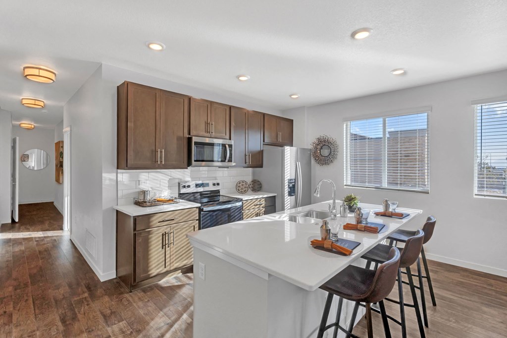 A kitchen with a white countertop and brown cabinets.