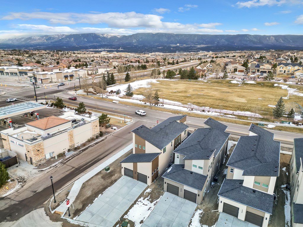 A view of a town with houses and buildings from a high vantage point.
