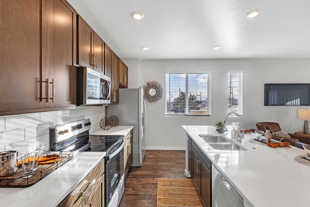 A modern kitchen with wooden cabinets and stainless steel appliances.