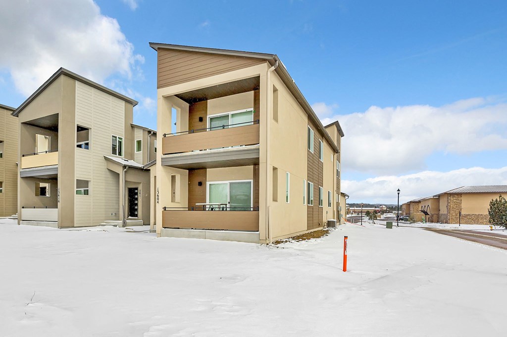 A row of houses with snow on the ground.