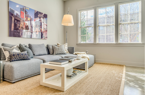 a living room with a gray couch and a coffee table