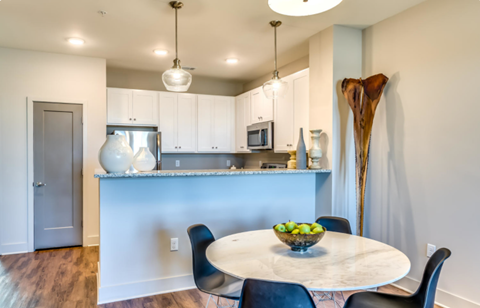 an open kitchen and dining room with a table and chairs