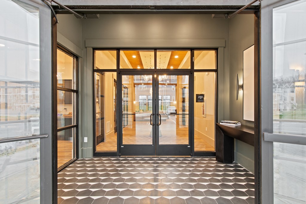 Lobby of a building with glass doors and a tiled floor at Hadley Place Apartments, Enola