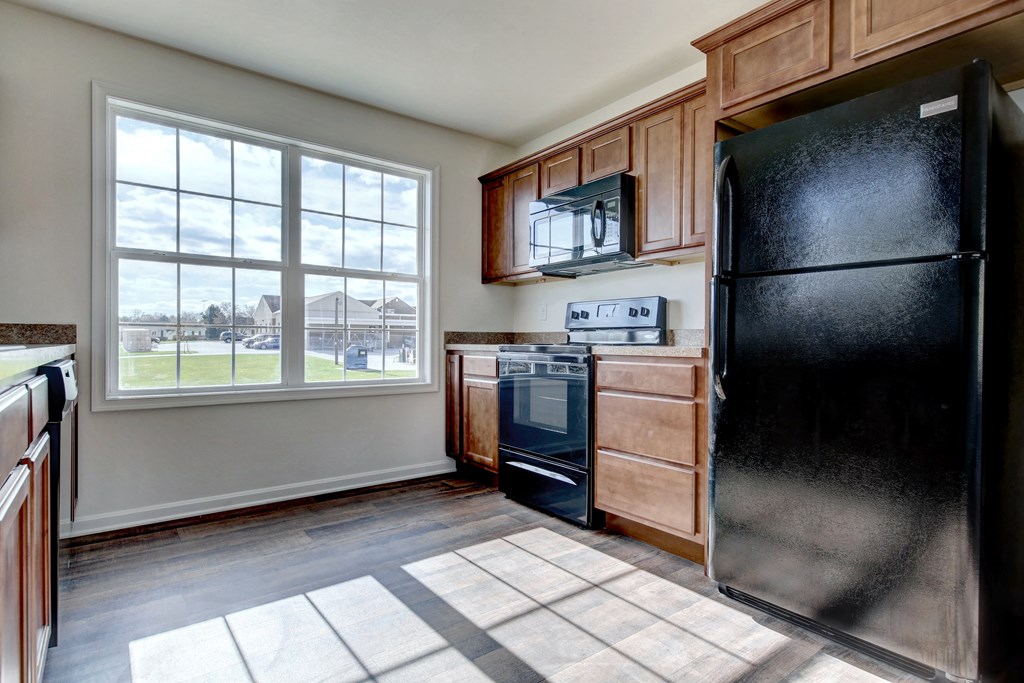 kitchen with wood cabinets and black appliances