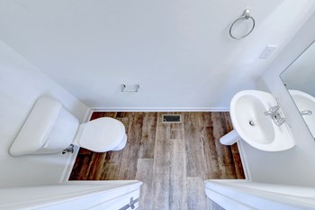 bathroom with hardwood floors and ceramic toilet and sink - Photo Gallery 31