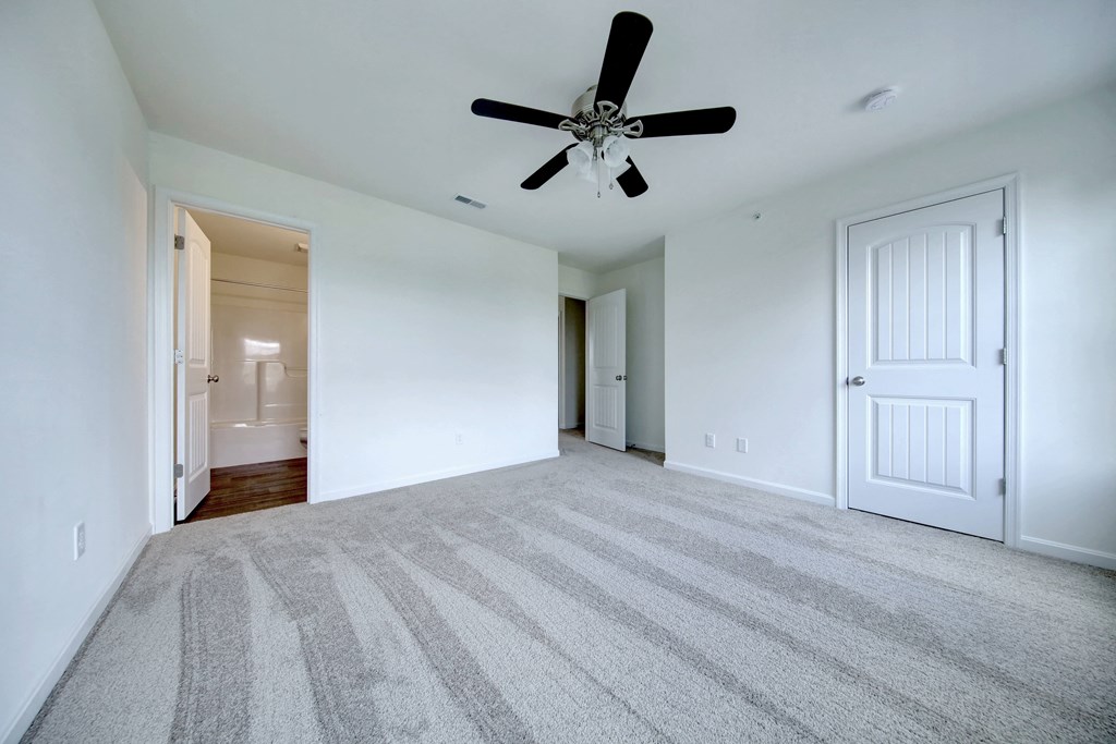bedroom with grey carpet natural light