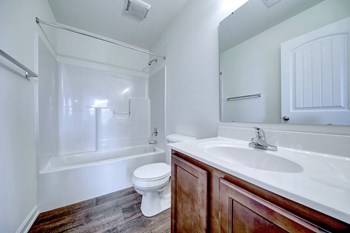 bathroom with hardwood floors and ceramic toilet and walnut vanity - Photo Gallery 35