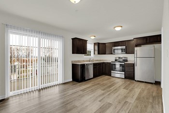 mocha cabinets with granite hardwood floors kitchen and dining looking into half bath and living room - Photo Gallery 7