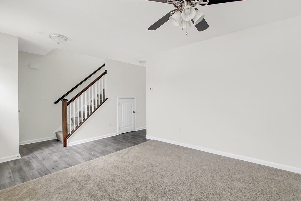 Living room with a ceiling fan and a staircase at Hudson Ridge, Red Lion, Pennsylvania.