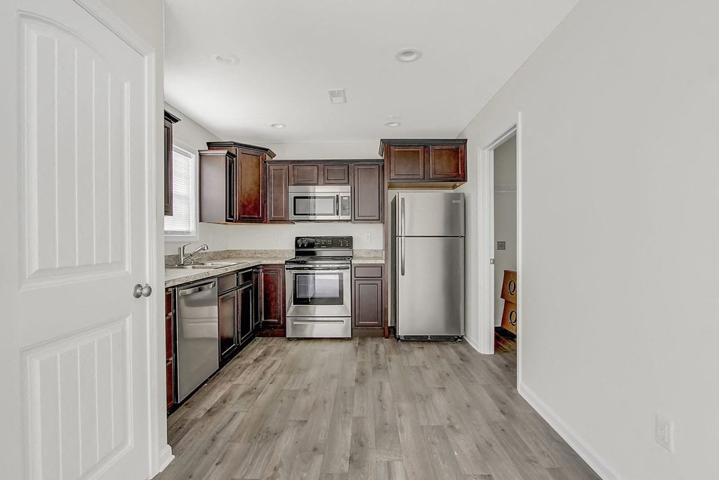 Kitchen with wooden floors and stainless steel appliances