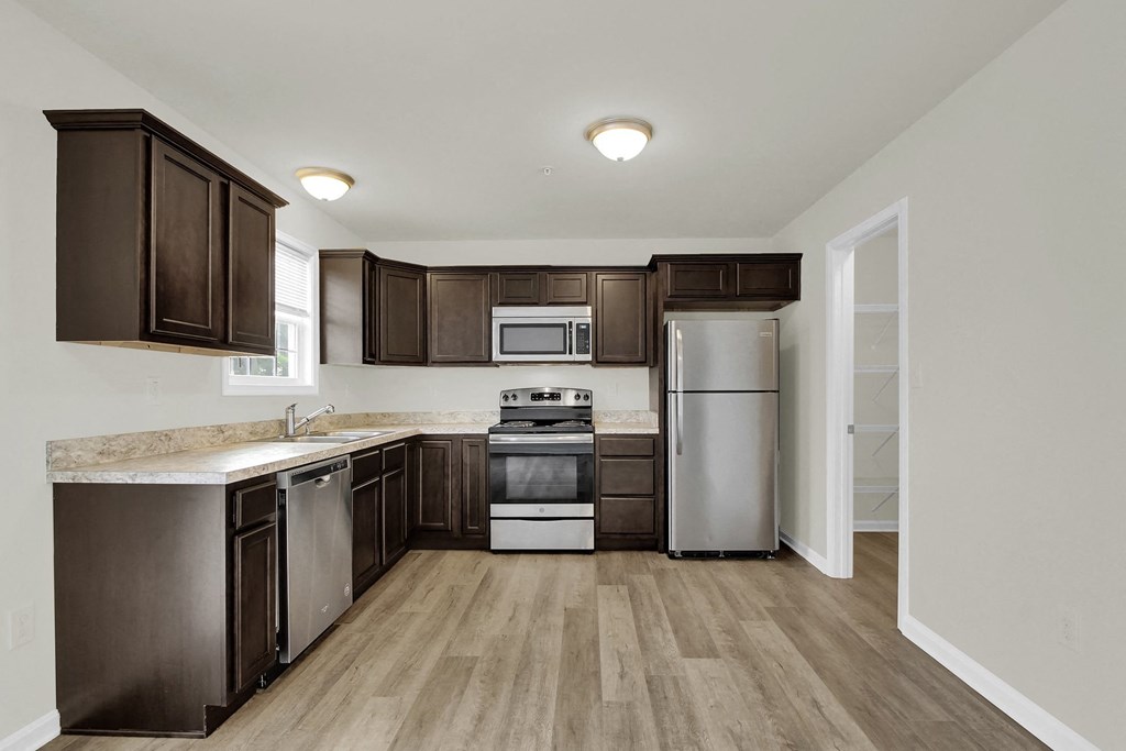 mocha cabinets with granite hardwood floors kitchen and dining looking into half bath and living room