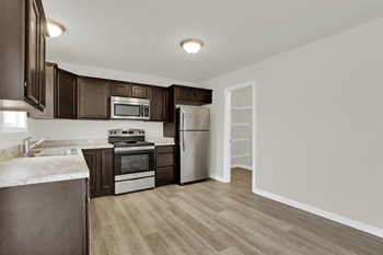 mocha cabinets with granite hardwood floors kitchen and dining looking into half bath and living room - Photo Gallery 9