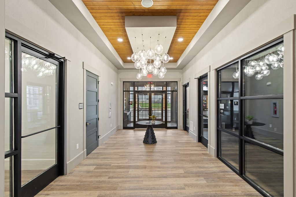 Long hallway with glass doors and a chandelierat Hadley Place Apartments, Pennsylvania, 17025