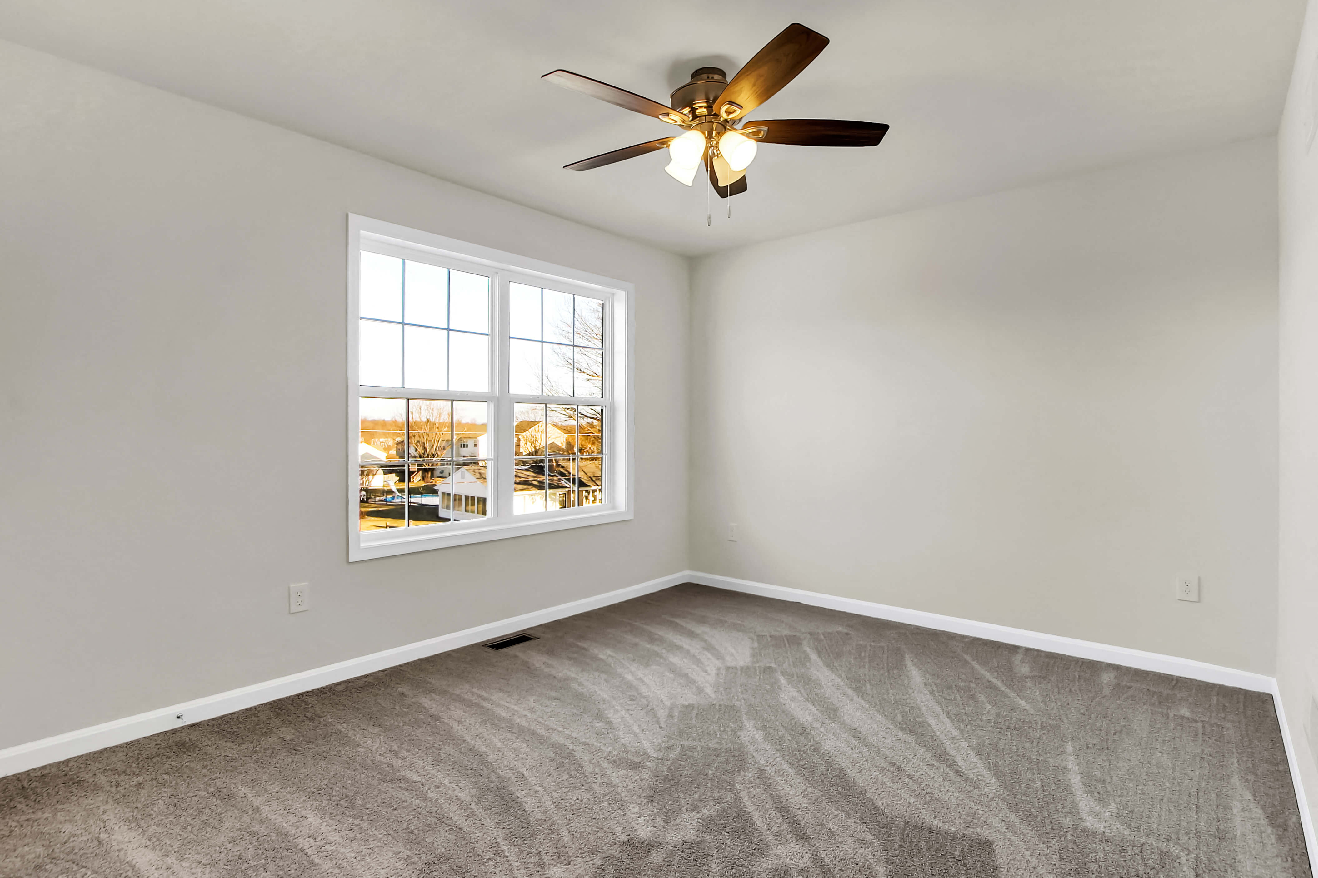 bedroom with grey carpet and natural light