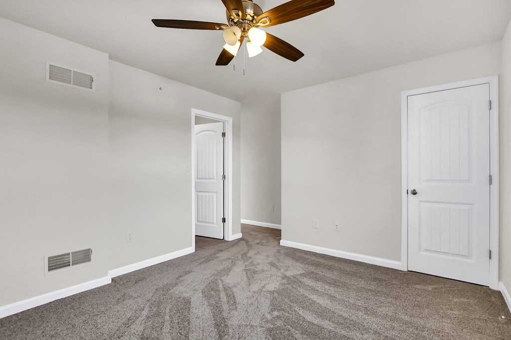 bedroom with grey carpet natural light